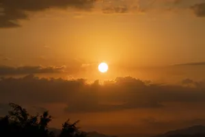 the sun is setting over the mountains in the sky jigsaw puzzle