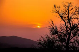 the sun is setting over a mountain range jigsaw puzzle