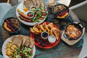 a table topped with plates of food and bowls of fruit jigsaw puzzle
