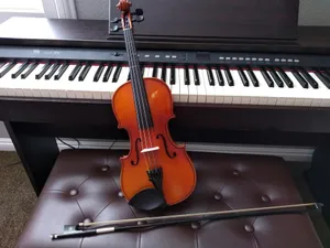 brown violin with brown violin bow beside white electronic keyboard jigsaw puzzle