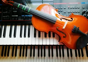 a violin sitting on top of a piano keyboard jigsaw puzzle