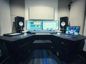 a computer desk with two monitors and a keyboard jigsaw puzzle