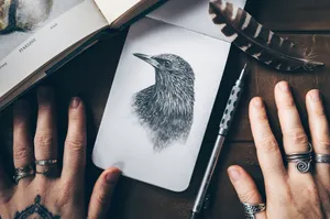 person holding white and black bird print card jigsaw puzzle