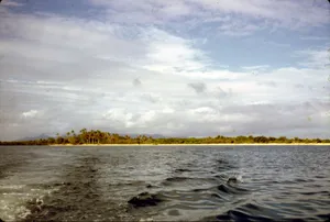 Beautiful view of a tropical island with blue sky and ocean waves. jigsaw puzzle