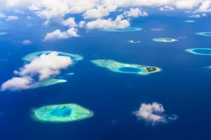 A breathtaking aerial view of tropical islands and azure blue waters, showcasing stunning natural beauty. jigsaw puzzle