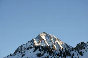 Snow-capped mountain peak against a clear blue sky in Valle d'Aosta, Italy. jigsaw puzzle