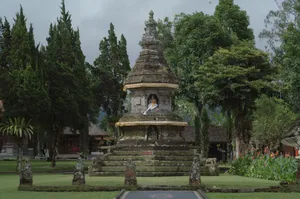 A serene ancient Balinese temple with a prominent Buddha statue in a lush garden setting, symbolizing spirituality and peace. jigsaw puzzle