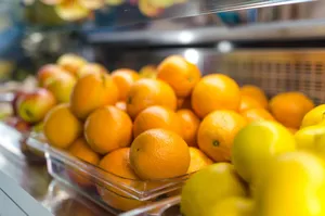 A vibrant display of fresh oranges and lemons in a market setting, emphasizing health and freshness. jigsaw puzzle