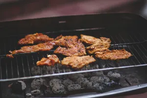 Delicious marinated meats sizzling on a charcoal barbecue grill, perfect for outdoor summer cooking. jigsaw puzzle