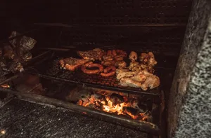 Close-up of assorted meats grilling over a flame, capturing the essence of rustic barbecue cooking. jigsaw puzzle