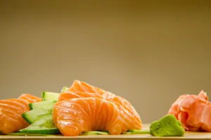 Close-up of fresh salmon sashimi with cucumber, wasabi, and ginger. jigsaw puzzle