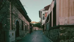 Explore a quaint and narrow alleyway lined with rustic buildings in a historic urban area. jigsaw puzzle
