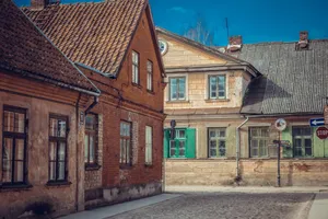 Explore the historic charm of medieval houses on a cobblestone street in Kuldīga, Latvia. jigsaw puzzle