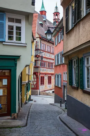 A vibrant narrow alleyway showcasing colorful traditional European architecture and cobblestone streets. jigsaw puzzle