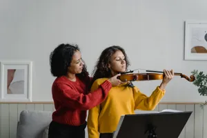 A woman teaches a young girl to play violin during a lesson at home, promoting music education. jigsaw puzzle