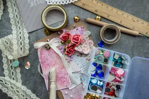 From above composition of various supplies for handicraft works placed on table with richly decorated greeting card jigsaw puzzle
