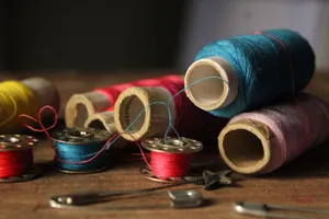 Vibrant spools of thread and sewing tools on a wooden table, perfect for crafting themes. jigsaw puzzle