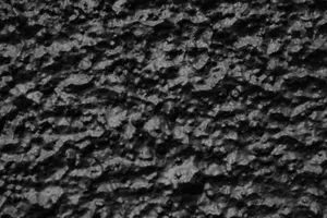 Close-up of a textured black surface showing detailed rough patterns. jigsaw puzzle