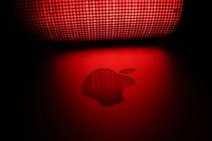 Artistic photo of a glowing apple-shaped graphic with a checkered pattern and red background. jigsaw puzzle