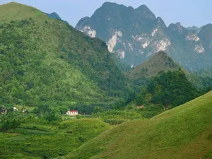 Green mountains and rolling hills with a small house. jigsaw puzzle