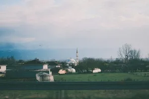 A green field with a church in the background jigsaw puzzle