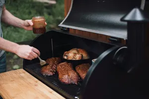 person holding knife slicing meat on black grill jigsaw puzzle