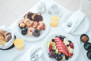 a white table topped with plates of food jigsaw puzzle