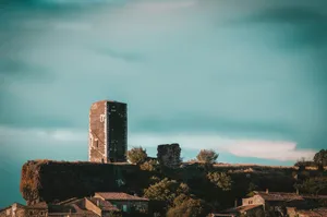 a tall tower sitting on top of a lush green hillside jigsaw puzzle