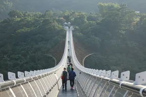 A group of people walking across a suspension bridge jigsaw puzzle