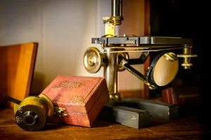 Antique microscope and wooden box on a table. jigsaw puzzle