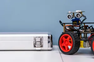 a toy car sitting next to a metal case jigsaw puzzle