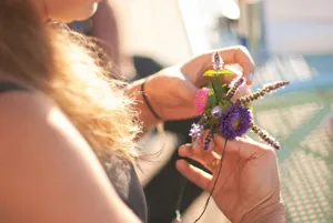 person holding pink and green flower jigsaw puzzle