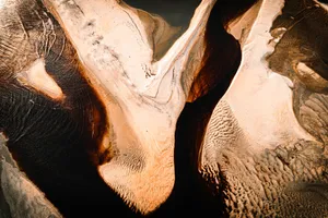 Aerial shot capturing the intricate textures and stunning patterns of desert sand dunes. jigsaw puzzle