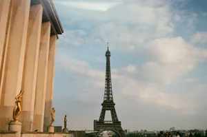 From below of observation tower and aged building exterior with sculptures under cloudy sky in Paris France jigsaw puzzle