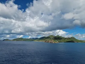 Beautiful Caribbean island with lush hills and a vast ocean under a bright sky. jigsaw puzzle