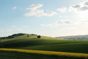 Scenic view of green rolling hills under a bright blue sky with clouds. jigsaw puzzle
