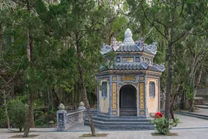 Tranquil scene of a historic pagoda surrounded by lush greenery in Huế, Vietnam. jigsaw puzzle