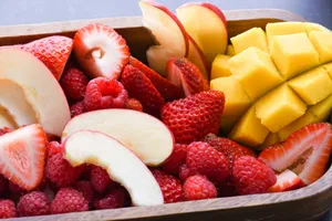 A colorful close-up of fresh sliced apples, strawberries, raspberries, and mango. jigsaw puzzle
