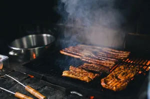 Close-up of grilled steaks sizzling on a smoky barbecue grill. jigsaw puzzle