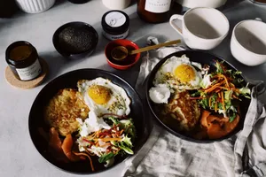 Delicious breakfast with fried eggs, salad, and smoked salmon on a rustic table. jigsaw puzzle