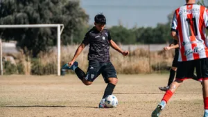 Action shot of a soccer player in motion kicking the ball on an outdoor field. jigsaw puzzle