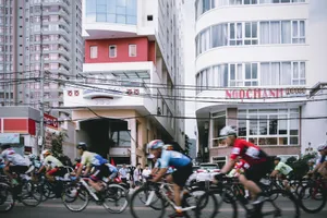 Dynamic street scene of cyclists racing through Vũng Tàu, Vietnam, against a backdrop of modern buildings. jigsaw puzzle