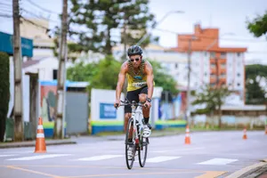 Man in cycling race on urban road, wearing helmet and sunglasses. jigsaw puzzle