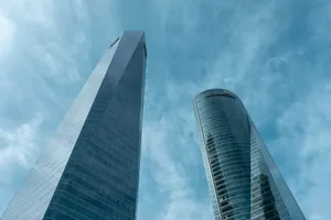 A low-angle view of two modern skyscrapers in Madrid, Spain against a clear blue sky. jigsaw puzzle