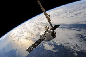 A satellite glides over Earth showcasing dramatic cloud formations and the vast expanse of space. jigsaw puzzle