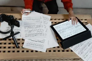 A musician analyzes sheet music on a tablet surrounded by paperwork. Ideal for music production themes. jigsaw puzzle