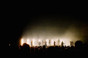 Silhouetted performers energize a concert crowd with dramatic stage lighting. jigsaw puzzle