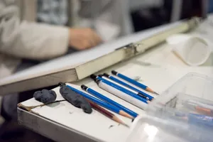 Close-up of art supplies and sketching pencils on a desk, suggesting a creative workspace. jigsaw puzzle