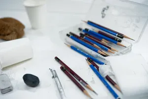 A collection of sketching tools and art supplies arranged on a desk, ideal for artists. jigsaw puzzle