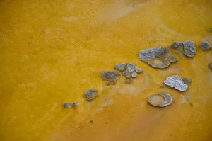 Close-up of a textured orange clay surface with natural cracks and formations. jigsaw puzzle